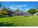 Spacious backyard features a screened-in pool area with seating, perfect for outdoor relaxation and entertaining at 17220 Countrybrook Ln, Orlando, FL 32820