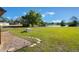 Picturesque backyard with lush lawn, picnic table, and serene pond view at 17220 Countrybrook Ln, Orlando, FL 32820