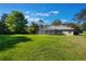 Expansive backyard featuring lush green lawn and screened-in patio, perfect for outdoor living at 17220 Countrybrook Ln, Orlando, FL 32820