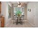 Cozy breakfast nook features a quaint table setting beneath a bright window and ceiling fan at 17220 Countrybrook Ln, Orlando, FL 32820