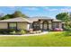 Inviting single-story home featuring a well-manicured lawn and colorful landscaping at 17220 Countrybrook Ln, Orlando, FL 32820
