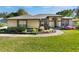 Beautiful one-story home with a lush green lawn and meticulously maintained landscaping at 17220 Countrybrook Ln, Orlando, FL 32820