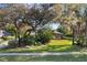 Exterior view of a home with mature trees, lush landscaping, and a sidewalk at 17220 Countrybrook Ln, Orlando, FL 32820