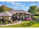 Single-story home with well-maintained landscaping, a green lawn, and mature trees at 17220 Countrybrook Ln, Orlando, FL 32820