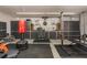 Home gym in garage featuring free weights, weight bench, and storage cabinets at 17220 Countrybrook Ln, Orlando, FL 32820