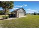 Detached garage with lush landscaping, an automatic door, and a stone-paved walkway, offers parking and storage at 17220 Countrybrook Ln, Orlando, FL 32820