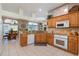 Open kitchen layout with wood cabinets, granite countertops, and breakfast nook at 17220 Countrybrook Ln, Orlando, FL 32820