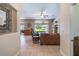Bright, neutral interior featuring tile flooring, a ceiling fan, and a view to the pool at 17220 Countrybrook Ln, Orlando, FL 32820