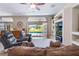 Inviting living room with a view of the pool and a built-in entertainment center at 17220 Countrybrook Ln, Orlando, FL 32820