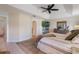 This bright main bedroom features modern decor, a ceiling fan, and an ensuite bath at 17220 Countrybrook Ln, Orlando, FL 32820