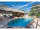 Backyard pool with screened enclosure and outdoor seating offers relaxation and entertainment with clear blue water at 17220 Countrybrook Ln, Orlando, FL 32820