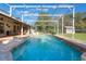A private pool is enclosed in a screened cage, and is surrounded by lush greenery and an inviting outdoor space at 17220 Countrybrook Ln, Orlando, FL 32820