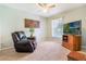 Inviting sitting area with recliner, natural light, and a ceiling fan at 17220 Countrybrook Ln, Orlando, FL 32820