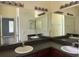 Bathroom featuring double sinks with dark cabinetry and ample lighting at 178 Chippendale Ter, Oviedo, FL 32765