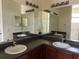 Bathroom featuring double sinks with dark cabinetry and ample lighting at 178 Chippendale Ter, Oviedo, FL 32765