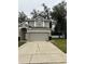 Well-maintained two-story home with a two-car garage and tidy front yard landscaping at 178 Chippendale Ter, Oviedo, FL 32765