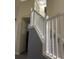 Staircase featuring white railings and gray walls leading to the upper level at 178 Chippendale Ter, Oviedo, FL 32765