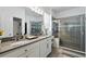 Bathroom featuring double sinks, vanity, and a glass-enclosed shower, offering a spa-like experience at 1822 Castleton Dr, St Cloud, FL 34771