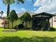 Landscaped backyard with a covered patio perfect for entertaining and relaxation at 1923 Willow Wood Dr, Kissimmee, FL 34746