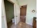 A well-lit bathroom with a toilet in a separate room at 1923 Willow Wood Dr, Kissimmee, FL 34746