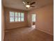 Cozy bedroom with carpet, ceiling fan, and adjoining bathroom at 1923 Willow Wood Dr, Kissimmee, FL 34746