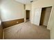 Bedroom with neutral paint, carpet flooring, closet and entry door at 1923 Willow Wood Dr, Kissimmee, FL 34746