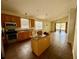 Open kitchen boasts granite countertops, stainless steel appliances, and center island at 1923 Willow Wood Dr, Kissimmee, FL 34746