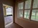 Light-filled sunroom leading to a screened lanai, offering seamless indoor-outdoor living at 1923 Willow Wood Dr, Kissimmee, FL 34746