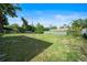 The backyard provides a large grassy expanse enclosed by a secure chainlink fence at 2311 Ashland Blvd, Orlando, FL 32808
