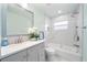 Modern bathroom featuring a sleek vanity, tiled walls, and tub/shower combination at 2311 Ashland Blvd, Orlando, FL 32808