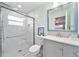 Bathroom featuring white marble walls, glass shower door, and a modern vanity sink at 2311 Ashland Blvd, Orlando, FL 32808