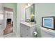 Clean bathroom with a vanity and a door to another room in the house at 2311 Ashland Blvd, Orlando, FL 32808