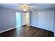 Spacious bedroom with ceiling fan, wood floors, closet, and ensuite bath at 2311 Ashland Blvd, Orlando, FL 32808