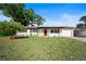 Charming single-story home featuring a well-manicured lawn, red front door, and inviting curb appeal at 2311 Ashland Blvd, Orlando, FL 32808
