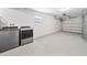 Spacious and clean garage featuring epoxy flooring, laundry area, and ample storage at 2311 Ashland Blvd, Orlando, FL 32808