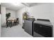 This laundry room includes a modern washer and dryer set and a table set with chairs at 2311 Ashland Blvd, Orlando, FL 32808