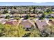 Aerial view of a home in a neighborhood surrounded by lush trees and well-maintained lawns at 24515 Bocage Way, Leesburg, FL 34748