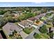 Aerial view of the property showcasing the yard, roof, and surrounding neighborhood at 24515 Bocage Way, Leesburg, FL 34748