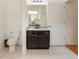 Well-lit bathroom with vanity and tile flooring at 24515 Bocage Way, Leesburg, FL 34748
