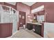 Plum-colored bathroom offers a glass-enclosed shower, a vanity, and a deep soaking tub at 24515 Bocage Way, Leesburg, FL 34748