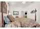 Comfortable bedroom showcases a four-poster bed, soft lighting, and a glimpse of the kitchen at 24515 Bocage Way, Leesburg, FL 34748