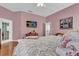 Bedroom boasts a ceiling fan, television, and direct access to outdoor space at 24515 Bocage Way, Leesburg, FL 34748