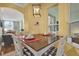 Dining nook with a square table, white chairs, and natural light at 24515 Bocage Way, Leesburg, FL 34748