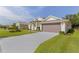 Single Gathering home with a two car garage and long driveway at 24515 Bocage Way, Leesburg, FL 34748