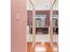 Hallway with mirror closet doors leading into main bathroom with vanity and walk-in shower at 24515 Bocage Way, Leesburg, FL 34748