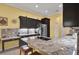 Beautiful kitchen featuring granite countertops, island with seating, and pendant lighting at 24515 Bocage Way, Leesburg, FL 34748