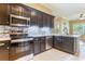 Well-equipped kitchen with stainless steel appliances and dark cabinets at 24515 Bocage Way, Leesburg, FL 34748