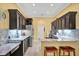 Modern kitchen features granite countertops, stainless steel appliances, and center island at 24515 Bocage Way, Leesburg, FL 34748