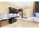 Kitchen featuring stainless steel appliances, dark cabinets, and granite countertops at 24515 Bocage Way, Leesburg, FL 34748