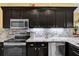 This kitchen features updated stainless steel appliances and white backsplash at 24515 Bocage Way, Leesburg, FL 34748